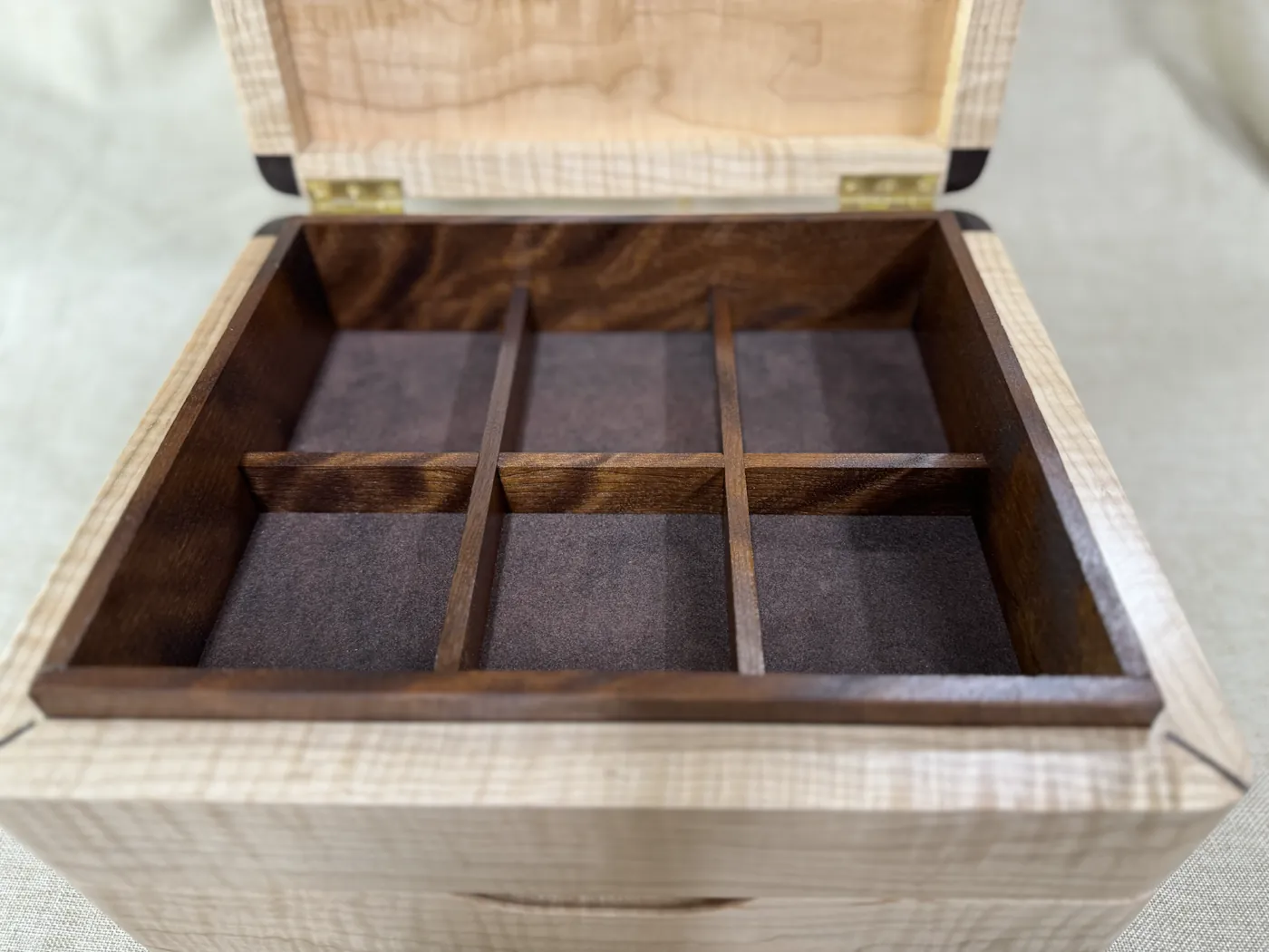 Walnut divided interior inside a custom tiger maple keepsake box