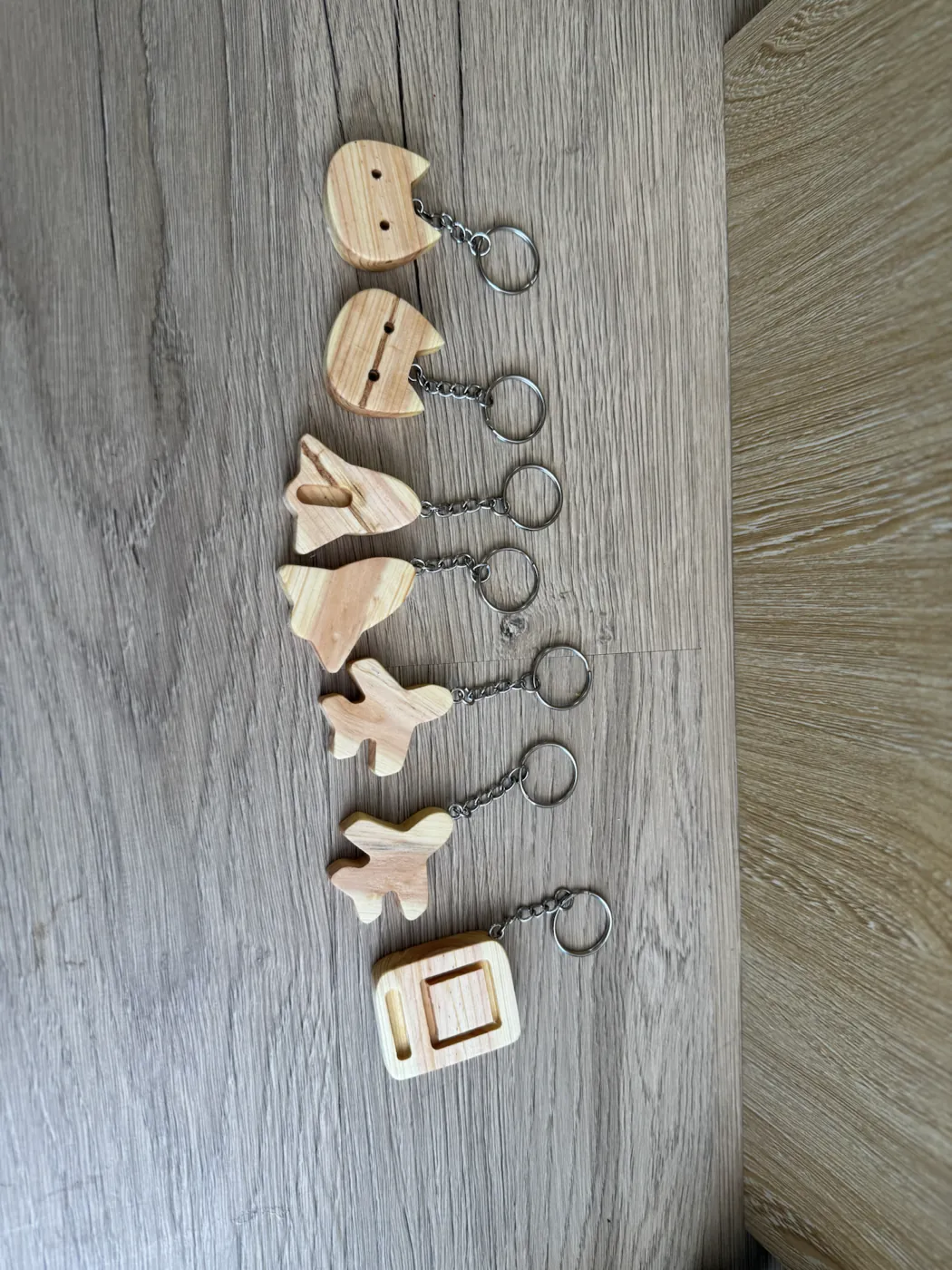 Small handmade keychains cut from a sentimental family pine branch