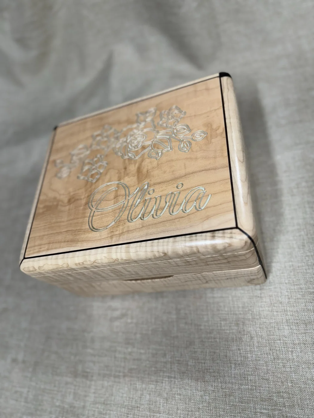 Curly maple jewellery box with a floral design and a name engraved on the lid