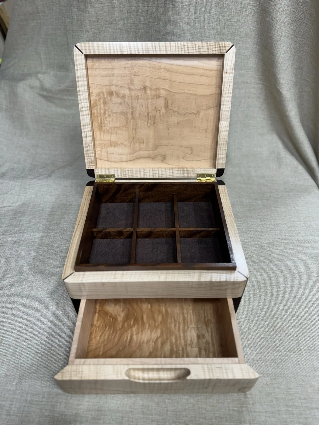 Personalized jewellery box open to show divided storage and a lower drawer