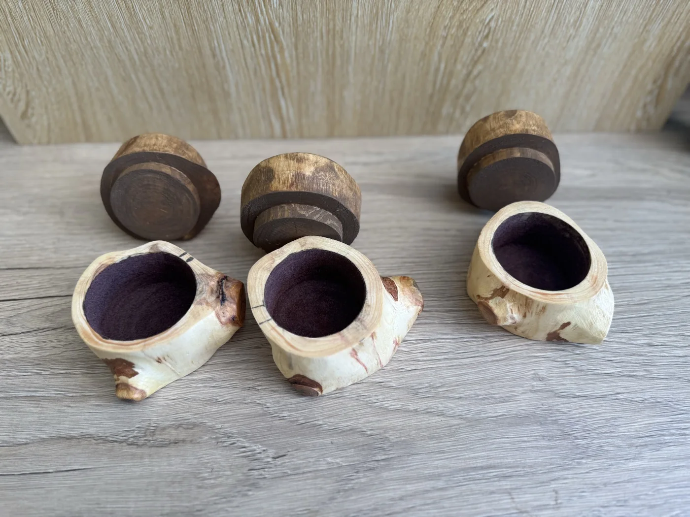 Three small branch-wood containers with their lids removed